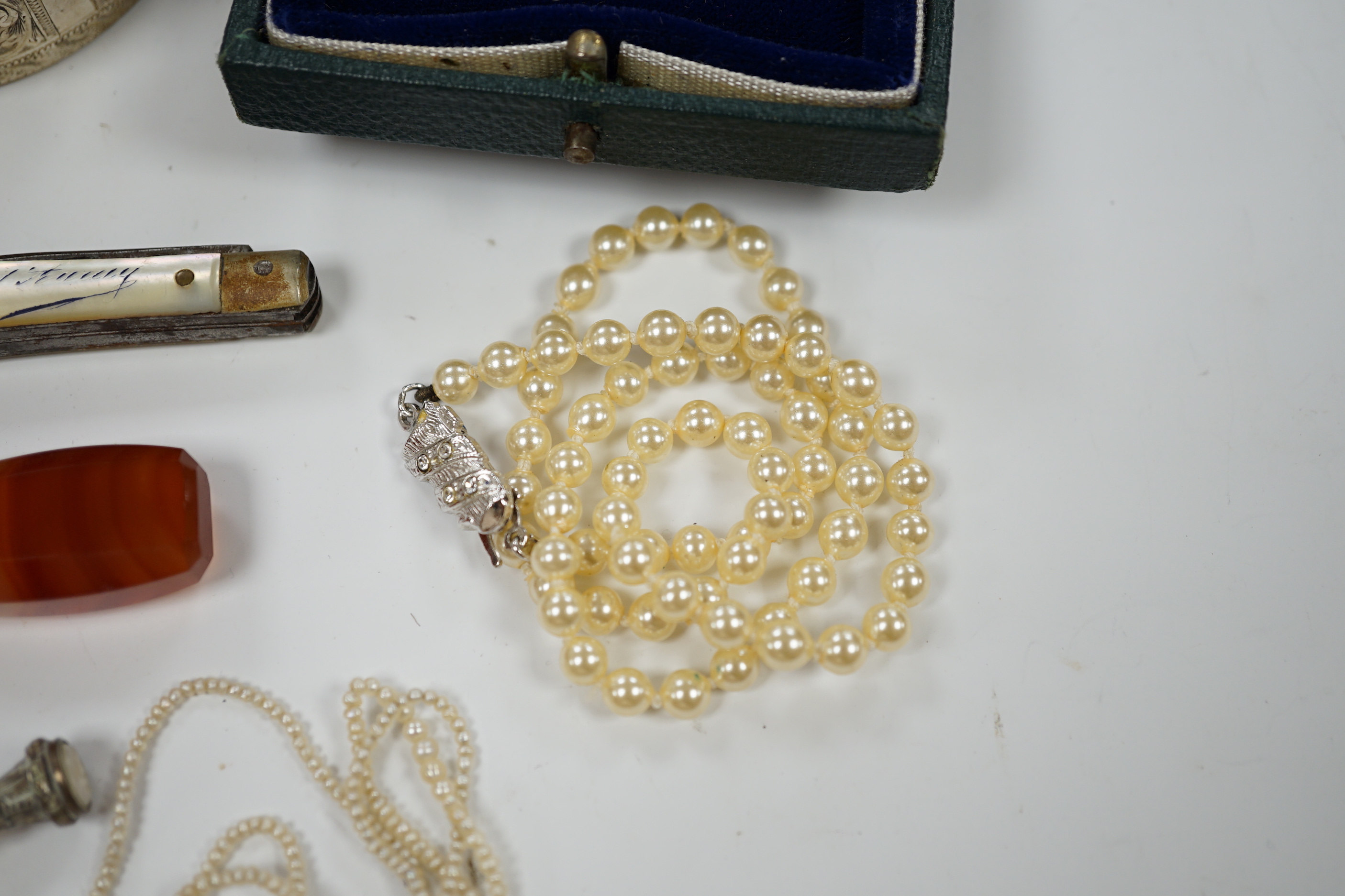 A modern 9ct gold and cultured pearl set circular brooch, 29mm, a silver hinged bangle, seed pearl necklace, a simulated pearl necklace, two seals, a 925 cannister and a pen knife.